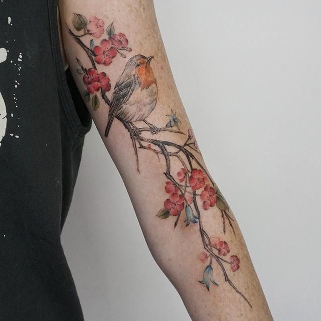 bird blossom tattoo under arm