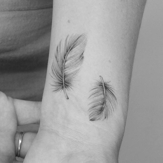 feather tattoo on arm