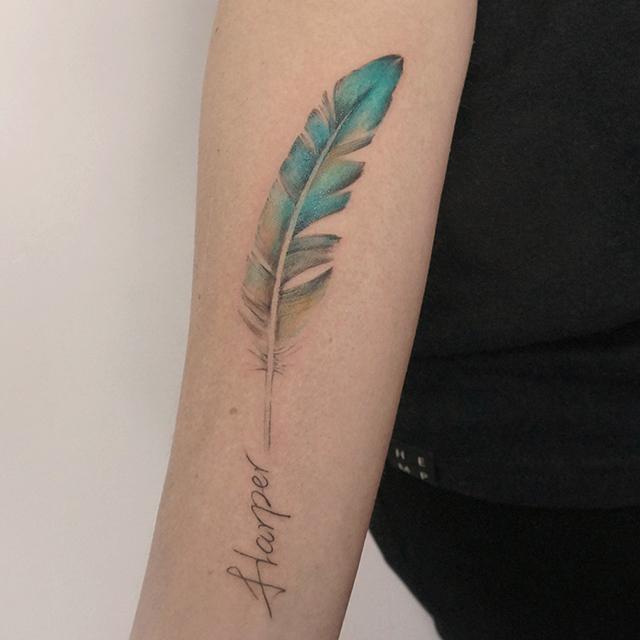 feather with words tattoo