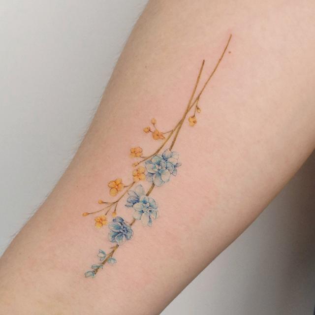 larkspur tattoo on arm
